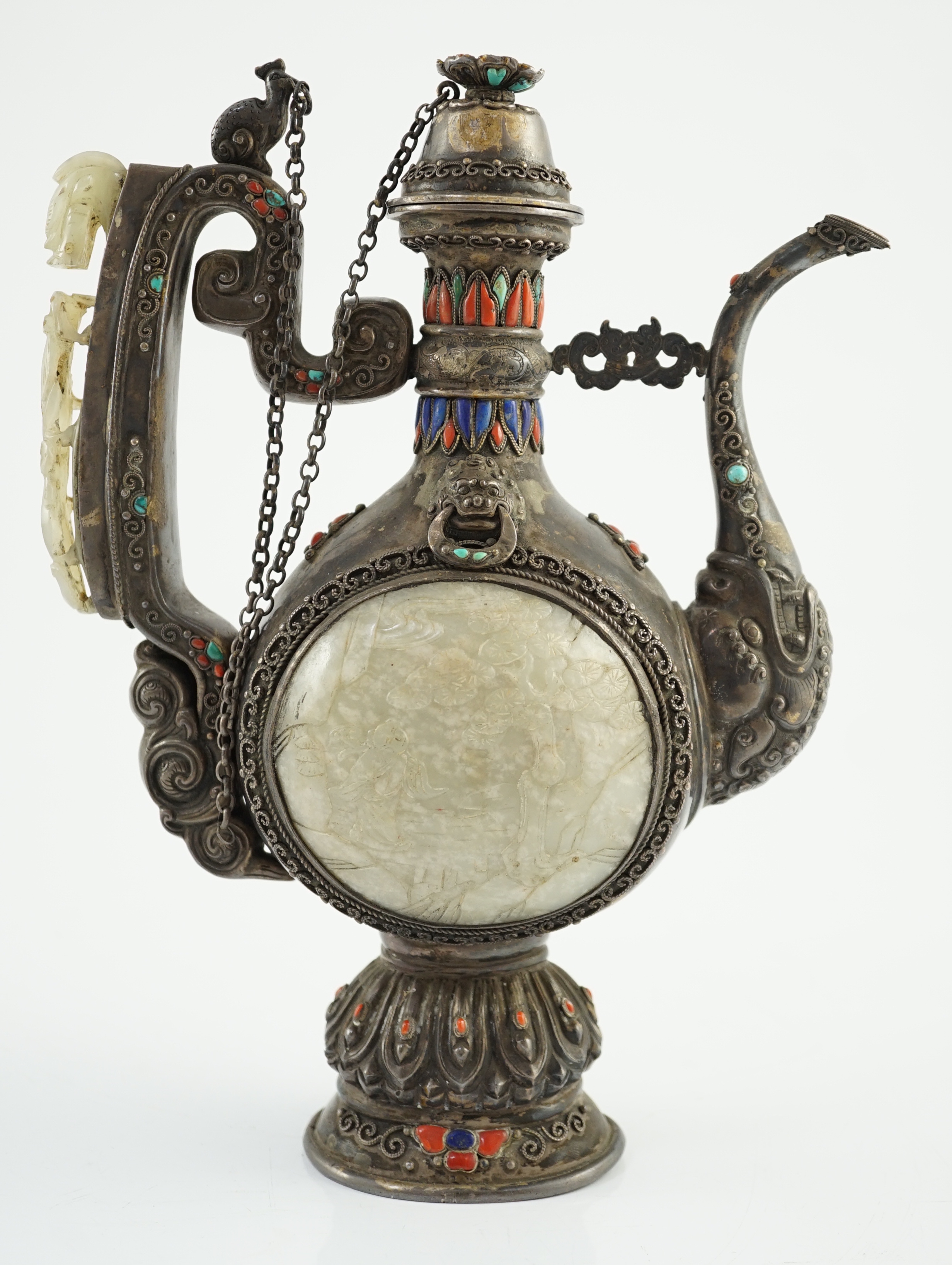 A Tibetan silver, jade, coral and hardstone mounted ewer, late 19th century, the Chinese pale celadon jades, 18th/19th century finial lacking stones